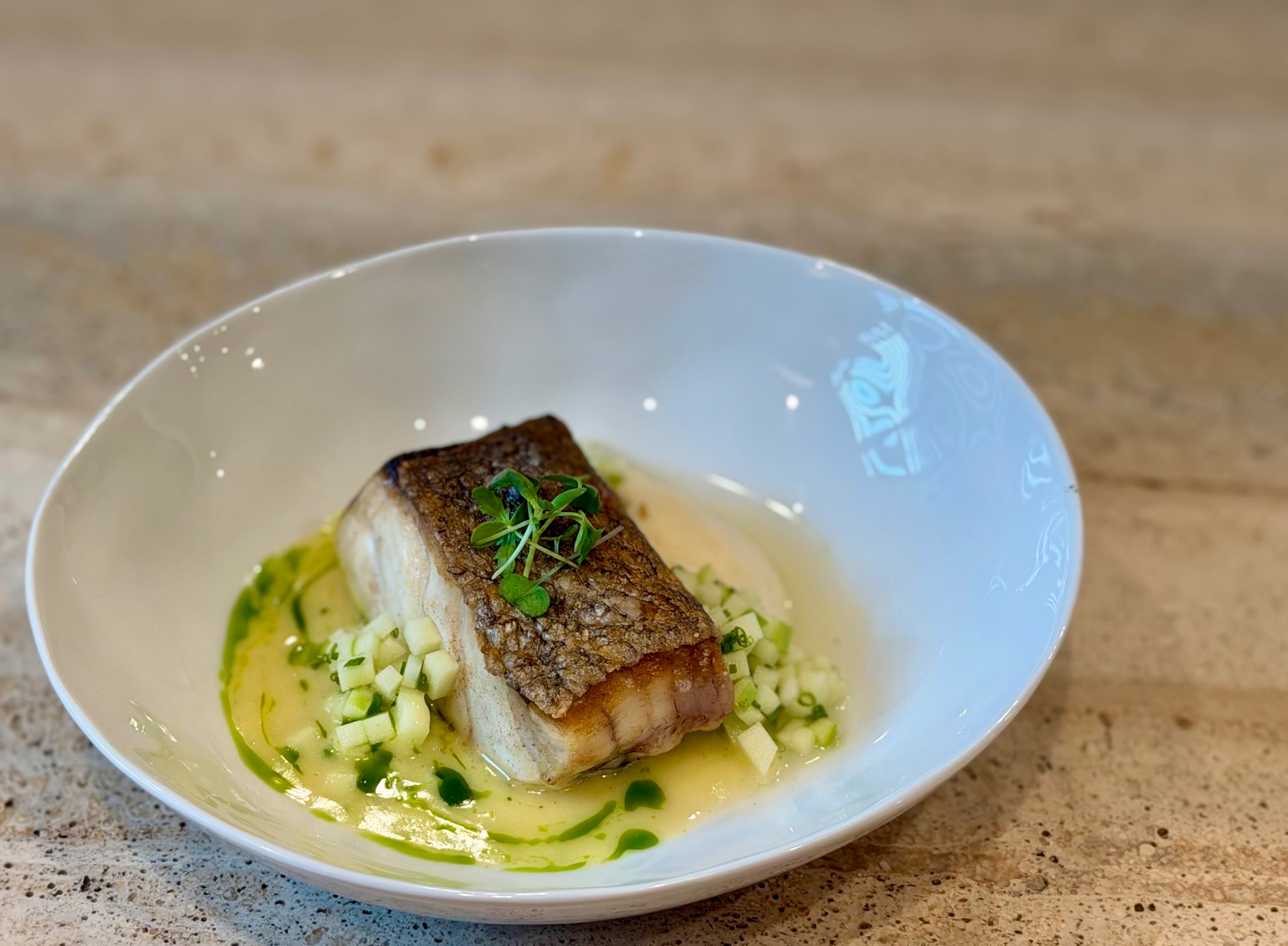 Seared white fish with crisp skin, herb oil and apple brunoise